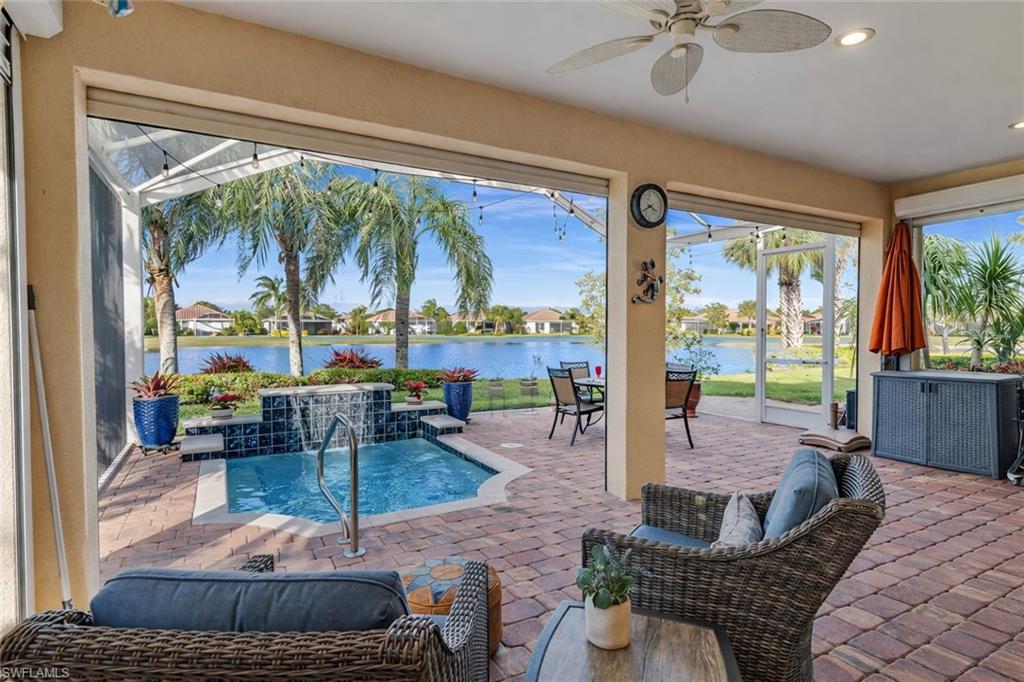 8595 Palermo Court Naples, FL 34114 - Photo 8 of 49 a living room with patio furniture and a floor to ceiling window