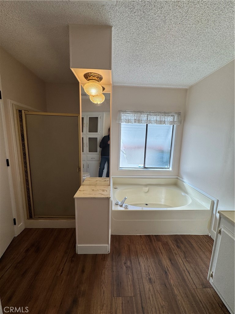 8651 Foothill Boulevard, Unit 157 Rancho Cucamonga, CA 91730 - Photo 14 of 19 a view of a room with wooden floor and cabinet