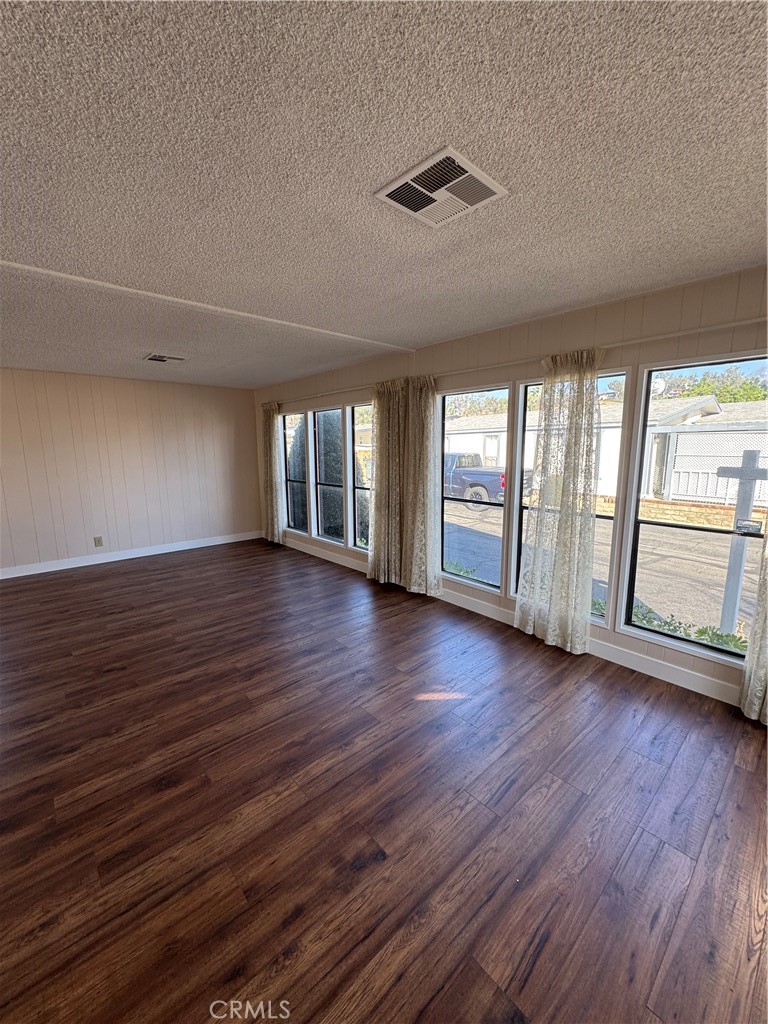8651 Foothill Boulevard, Unit 157 Rancho Cucamonga, CA 91730 - Photo 2 of 19 a view of an empty room with wooden floor and a window