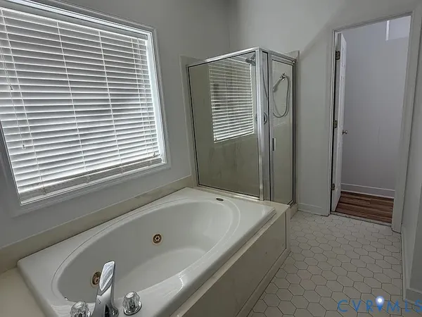 a bathroom with a bathtub and a shower