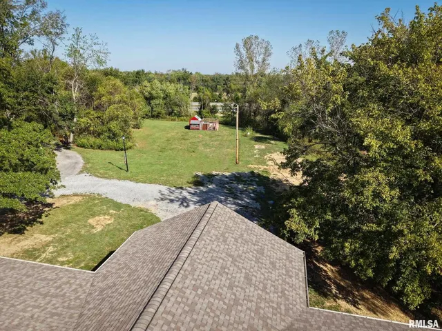 a kitchen with stainless steel appliances granite countertop a stove top oven a sink dishwasher a dining table and chairs with wooden floor