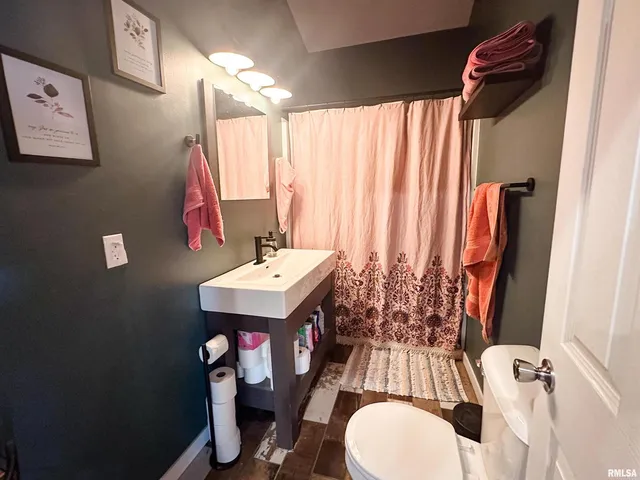 a living room with furniture ceiling fan and a rug