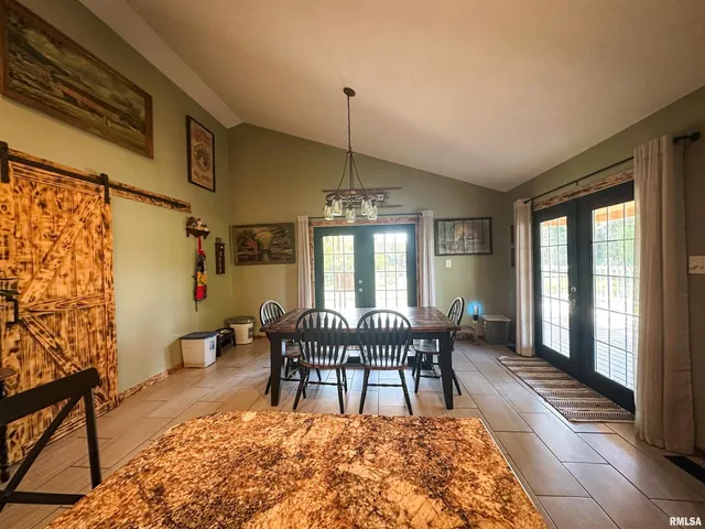 a living room with furniture a flat screen tv and a window