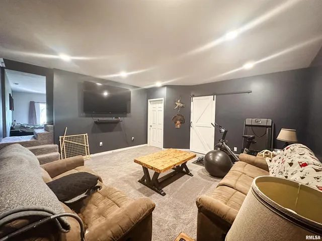 a view of a living room with clothes and storage