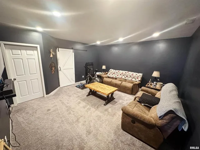 a living room with furniture and flat screen tv