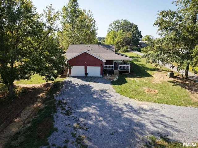 a view of a house with a big yard and large trees