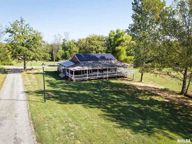a view of a house with a yard and street