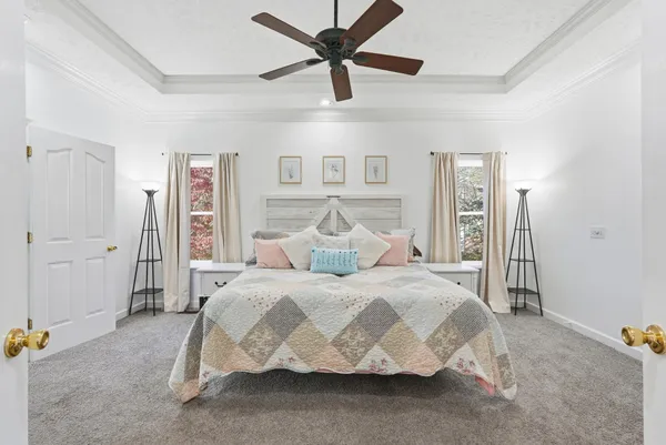 a large bedroom with a bed and a chandelier