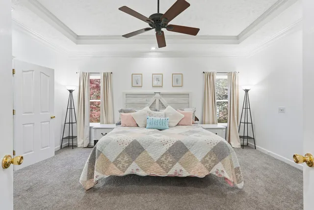 a large bedroom with a bed and a chandelier