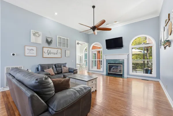 a living room with furniture a fireplace and a flat screen tv