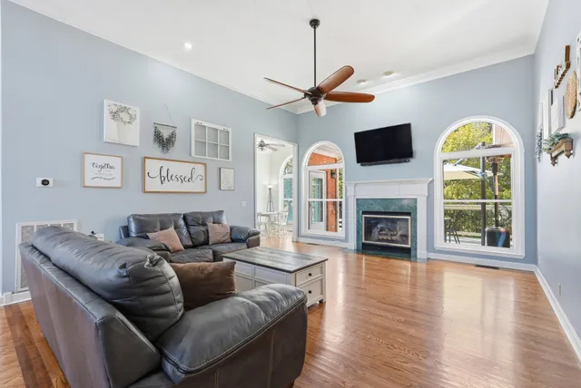 a living room with furniture a fireplace and a flat screen tv