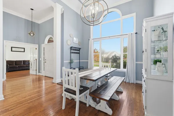 a view of a dining room with furniture window and wooden floor