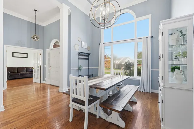a view of a dining room with furniture window and wooden floor