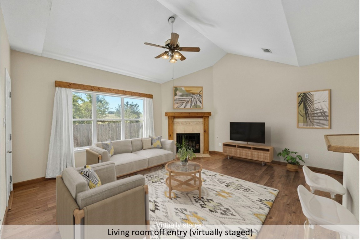 1907 Fast Filly Avenue Pflugerville, TX 78660 - Photo 1 of 1 a living room with furniture a fireplace and a flat screen tv