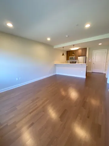 a view of a room with wooden floor and a window