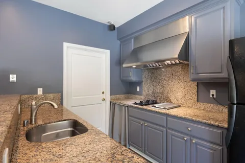 a bathroom with a double vanity sink mirror and toilet