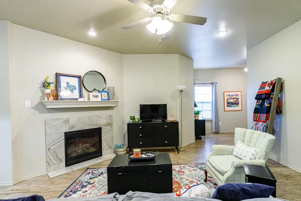 a living room with furniture a flat screen tv and a fireplace