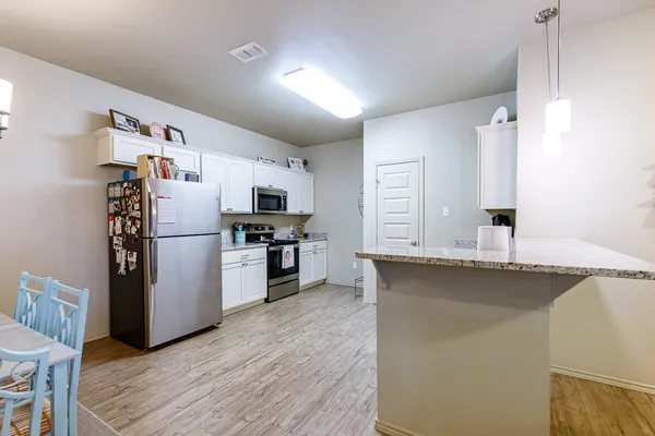 a kitchen with stainless steel appliances a refrigerator and a sink