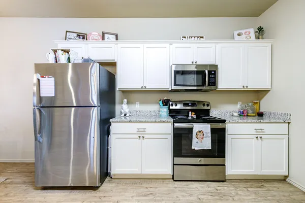 a kitchen with a refrigerator and a stove