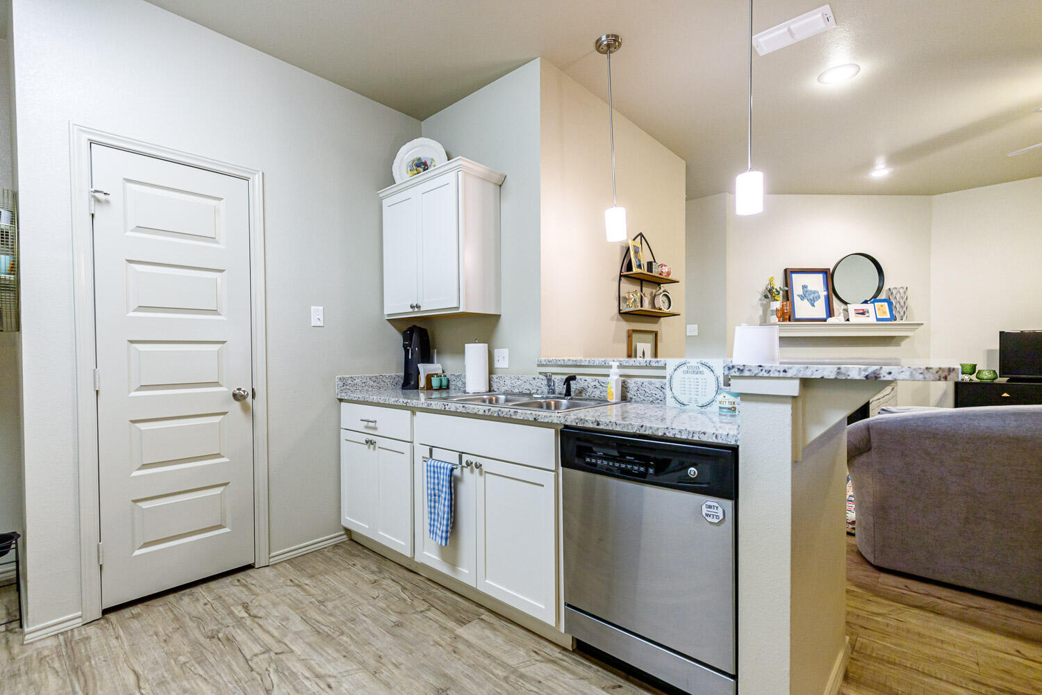6702 Pontiac Avenue Lubbock, TX 79424 - Photo 18 of 41 a kitchen with a sink cabinets and wooden floor