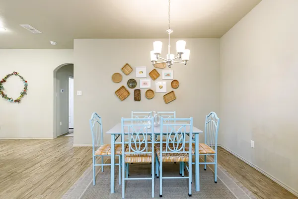 a view of a dining room with furniture and chandelier