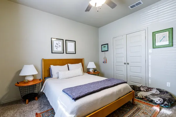 a bedroom with a bed and a chandelier