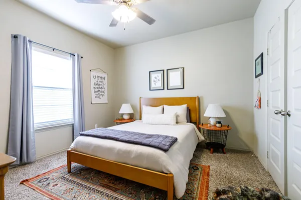 a bedroom with a bed and a chandelier