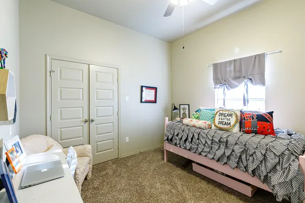 a bedroom with a bed and a window