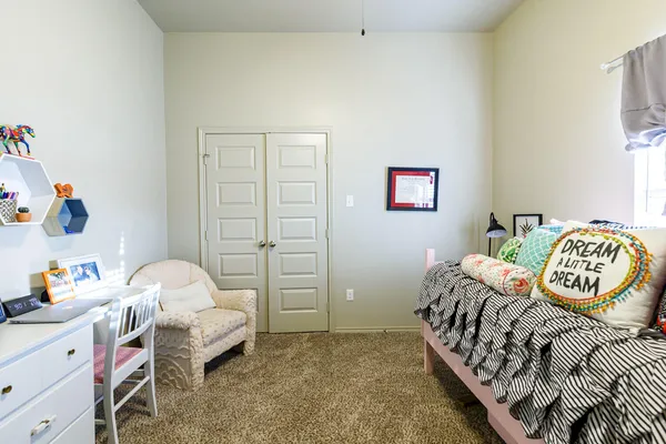 a bedroom with a bed and a window