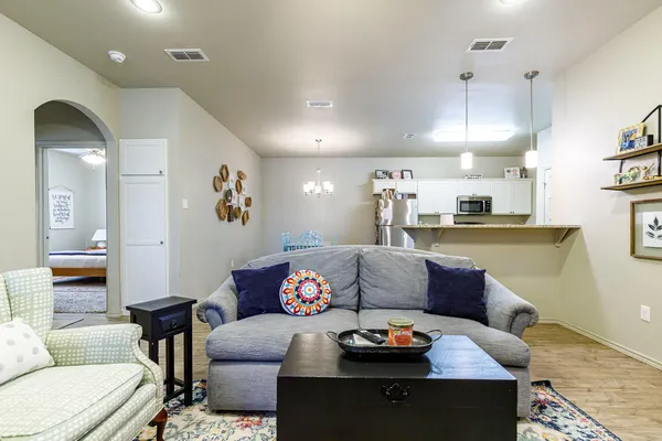 a living room with furniture and wooden floor