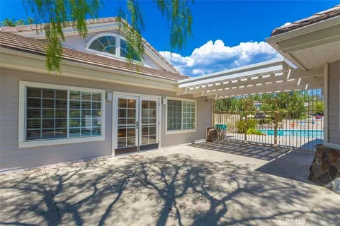 a view of a patio with dining table and chairs