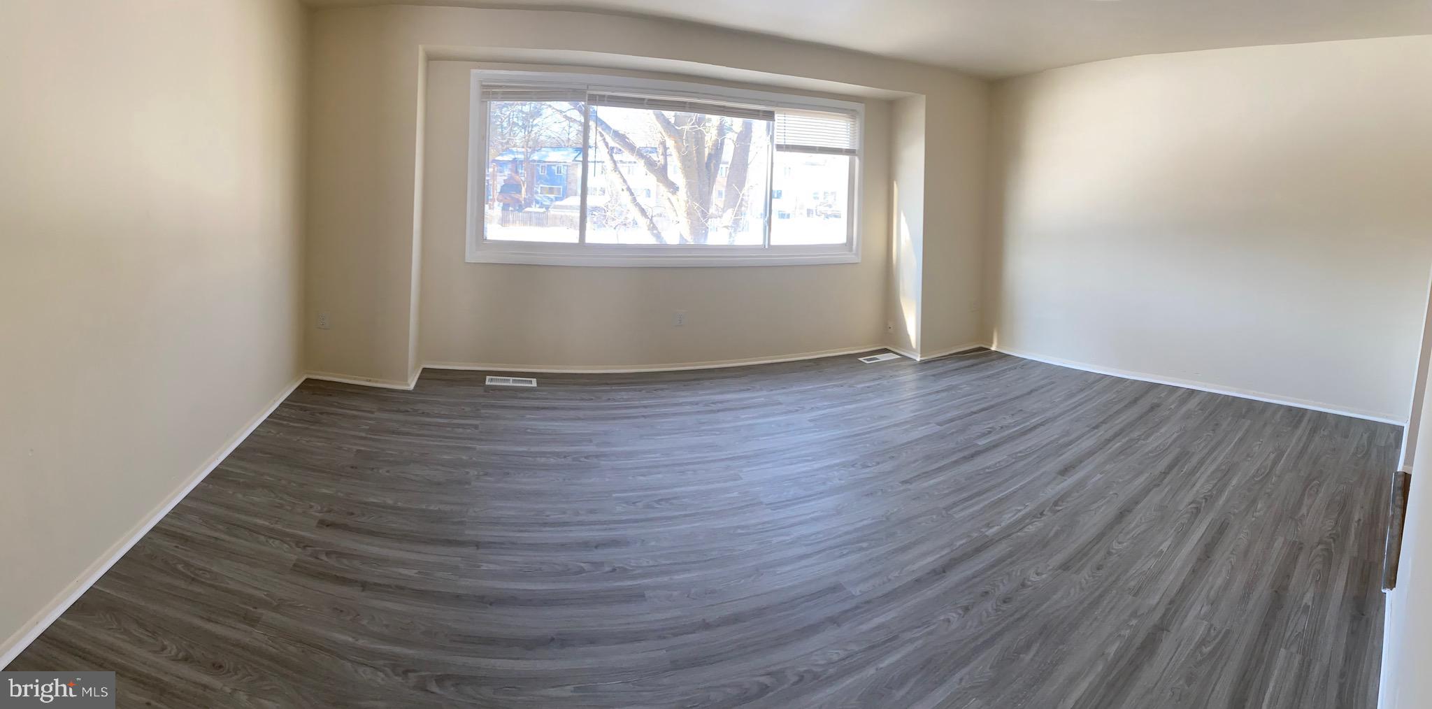 9323 Matador Road Columbia, MD 21045 - Photo 2 of 14 an empty room with wooden floor and windows