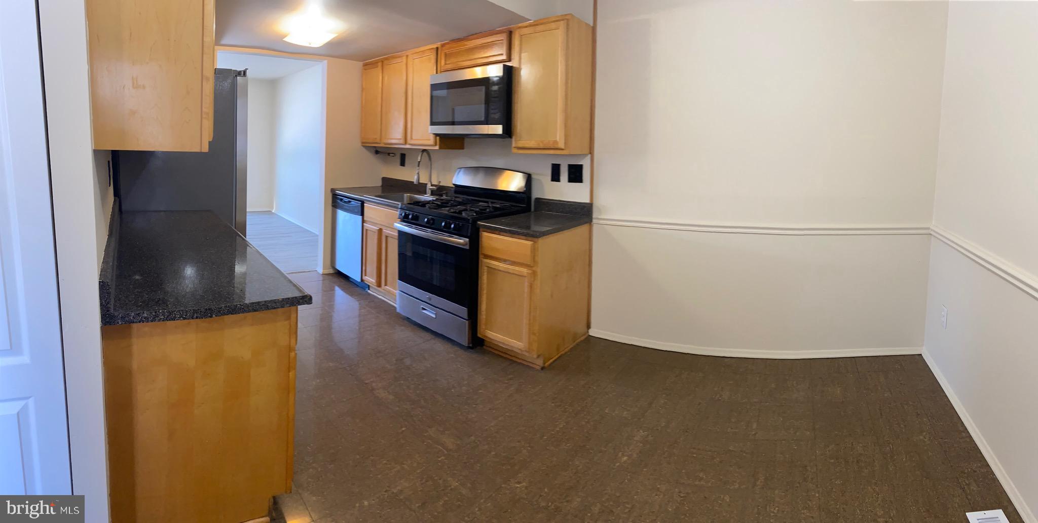 9323 Matador Road Columbia, MD 21045 - Photo 4 of 14 a kitchen with stainless steel appliances a refrigerator sink and stove