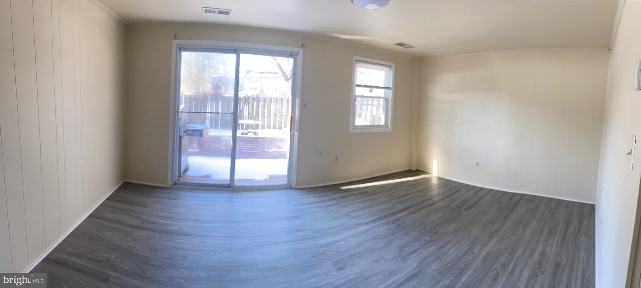 9323 Matador Road Columbia, MD 21045 - Photo 7 of 14 an empty room with wooden floor and windows