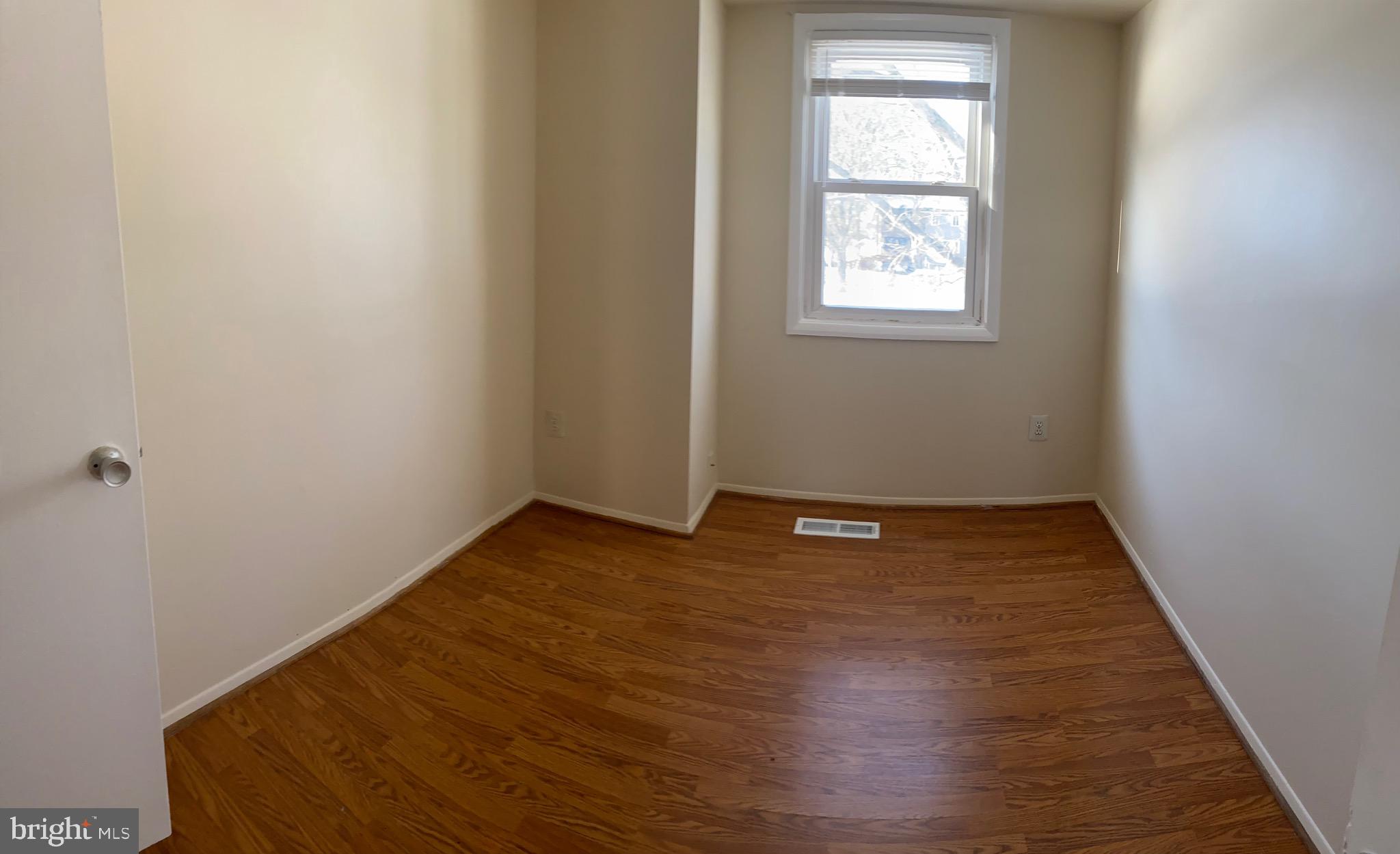 9323 Matador Road Columbia, MD 21045 - Photo 9 of 14 an empty room with wooden floor and windows