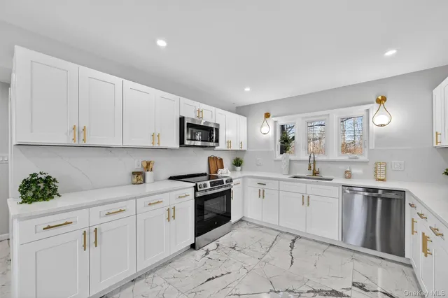 a view of a hallway with wooden floor and a living room