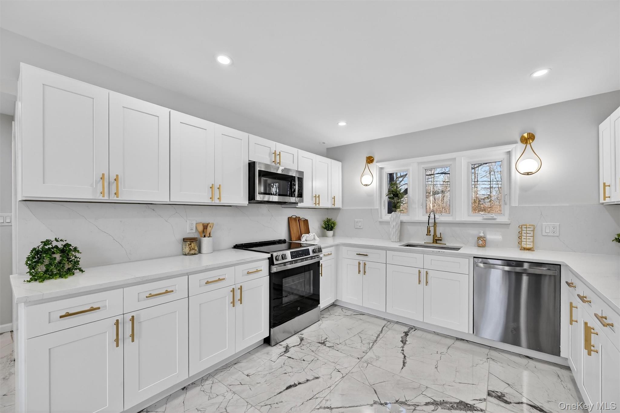 503 Station Road Rock Tavern, NY 12575 - Photo 12 of 47 Kitchen with appliances with stainless steel finishes, light marble finish floors, white cabinetry, light stone countertops, and recessed lighting