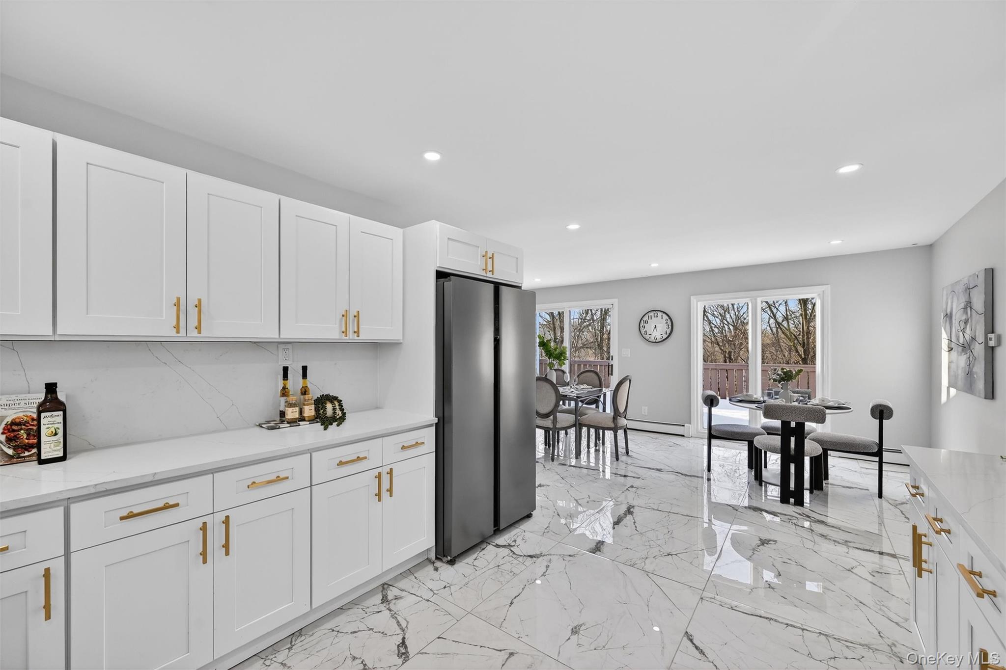 503 Station Road Rock Tavern, NY 12575 - Photo 13 of 47 Kitchen featuring freestanding refrigerator, light stone counters, white cabinets, light marble finish floors, and recessed lighting