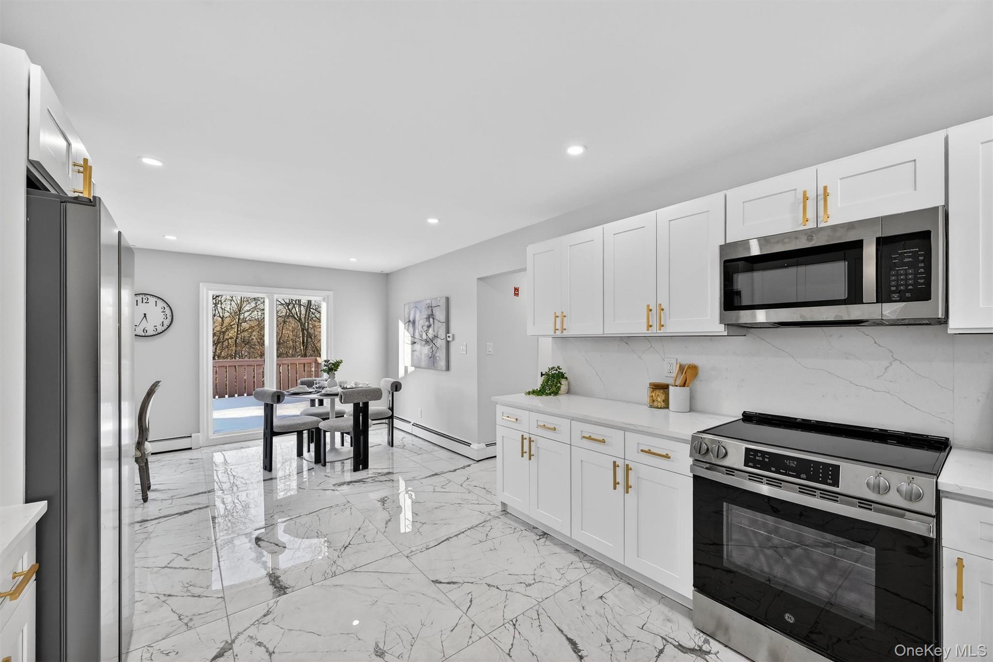 503 Station Road Rock Tavern, NY 12575 - Photo 14 of 47 Kitchen with appliances with stainless steel finishes, recessed lighting, white cabinets, backsplash, and light stone countertops