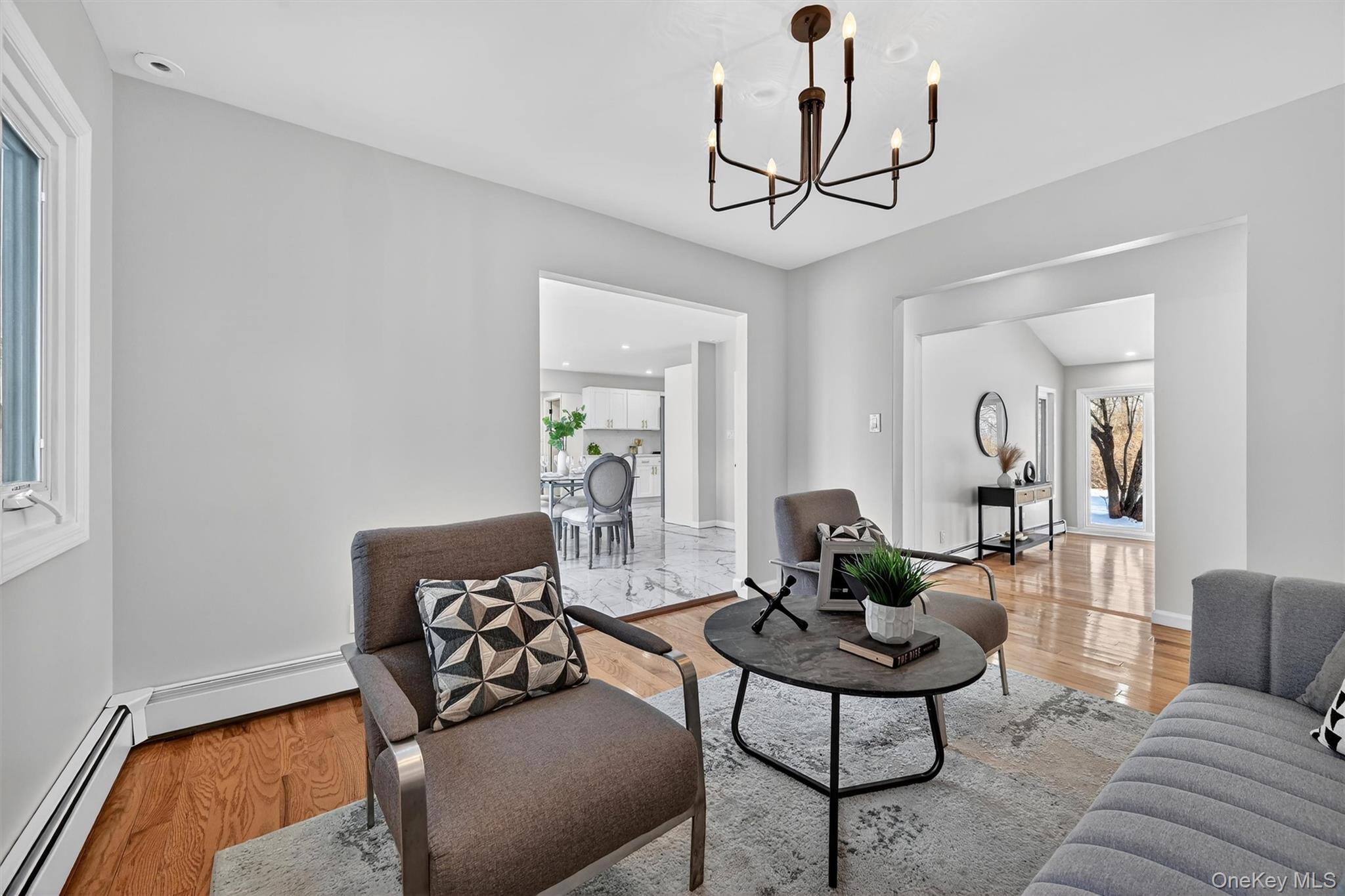 503 Station Road Rock Tavern, NY 12575 - Photo 22 of 47 Living area featuring wood finished floors, recessed lighting, a chandelier, and a baseboard heating unit