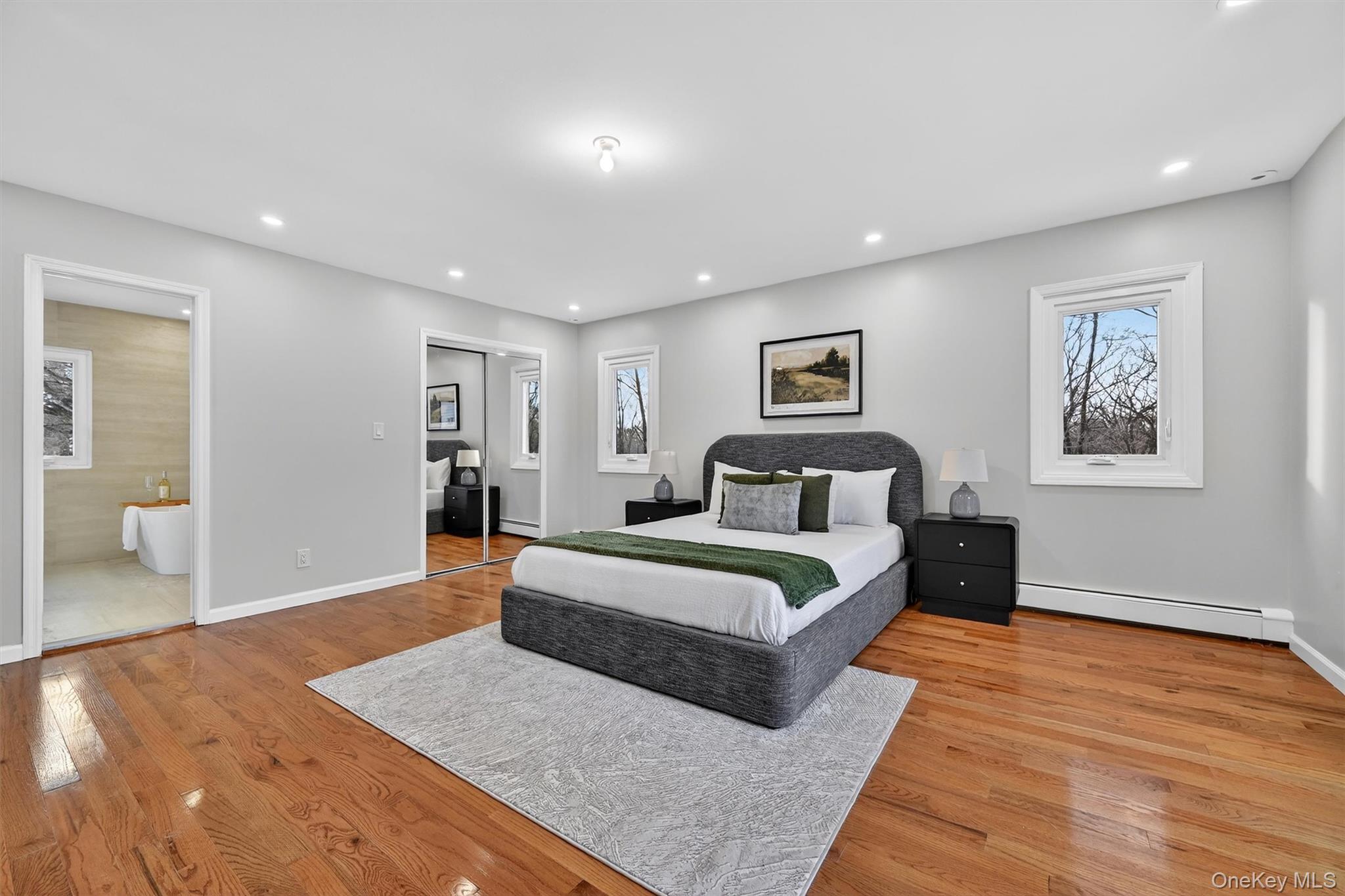 503 Station Road Rock Tavern, NY 12575 - Photo 24 of 47 Bedroom with light wood finished floors, a baseboard radiator, recessed lighting, a closet, and multiple windows