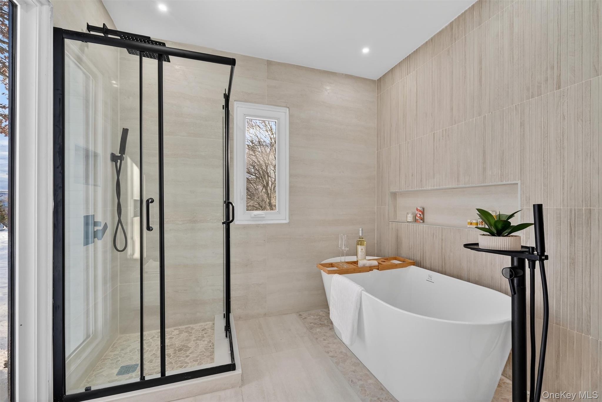 503 Station Road Rock Tavern, NY 12575 - Photo 28 of 47 Bathroom with a freestanding tub, a stall shower, and tile walls