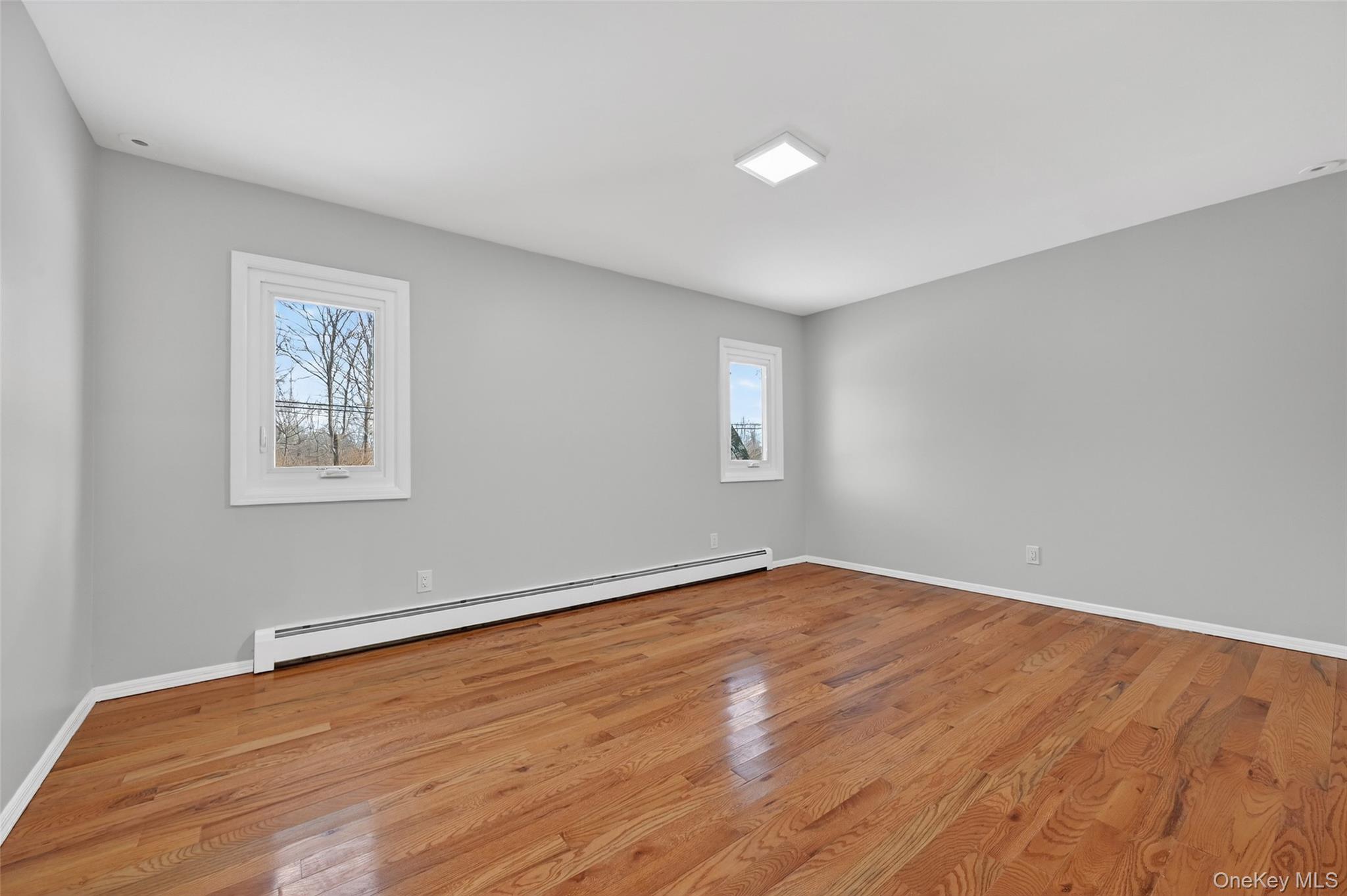 503 Station Road Rock Tavern, NY 12575 - Photo 33 of 47 Empty room with baseboard heating and light wood-style floors