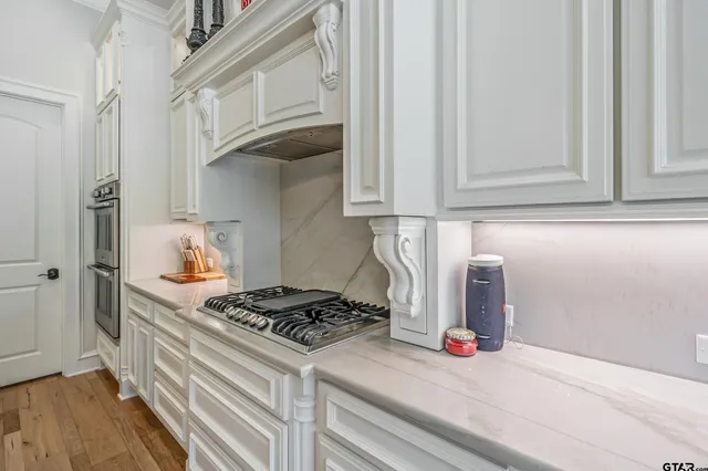 a kitchen with stainless steel appliances granite countertop a stove and a refrigerator