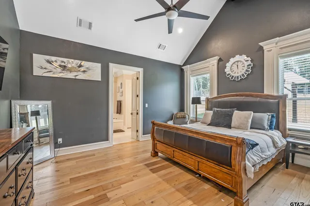 a bedroom with a bed and a chandelier