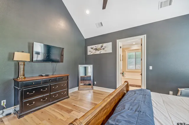 a bed room with a bed and a television