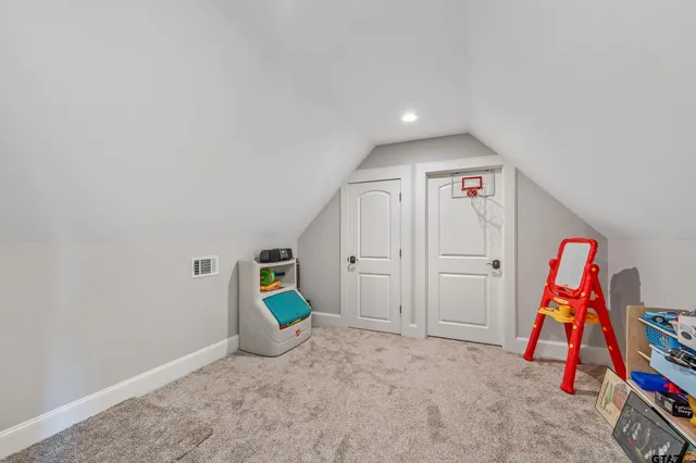 a view of play room with stairs and closet