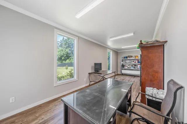 a dining room with furniture and a window