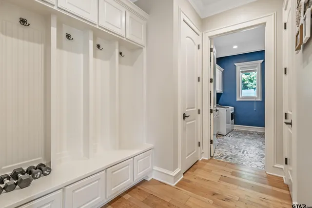 a view of a hallway with wooden floor and staircase