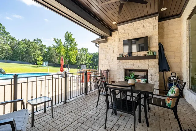 a view of a patio with a table and chairs